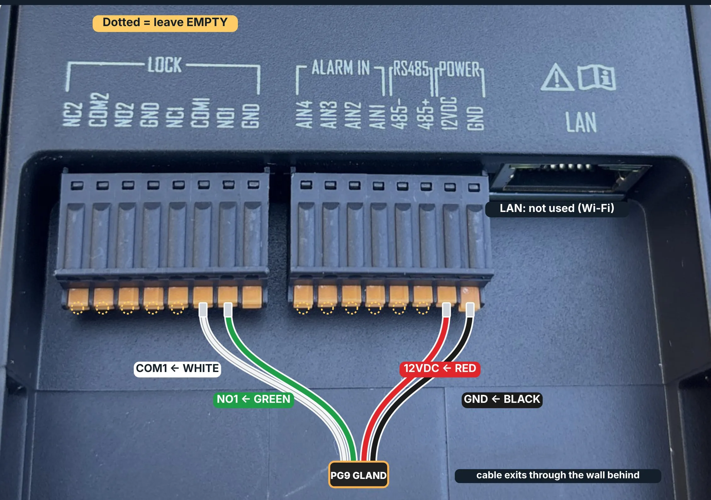 Hikvision door station terminal block as wired on site, with the relay, power and ground cores labelled